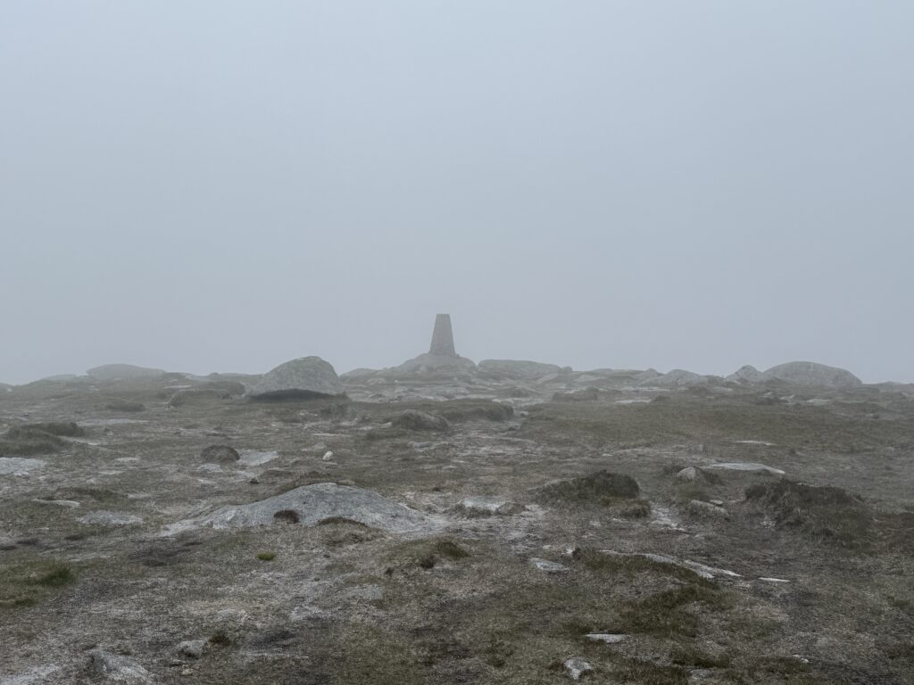 The trig point that marks the summit of Tonelagee. Visibility is low to to cloud cover. 