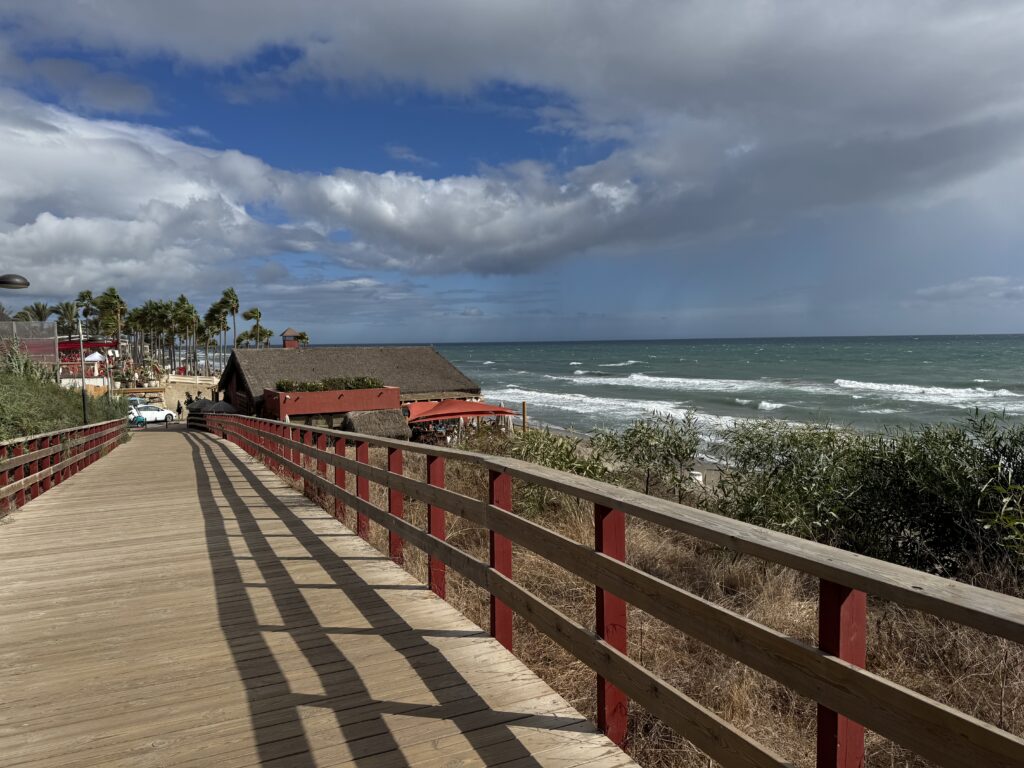 A sloping boardwalk with views out to the sea during a week in Elviria with a 3 year old.