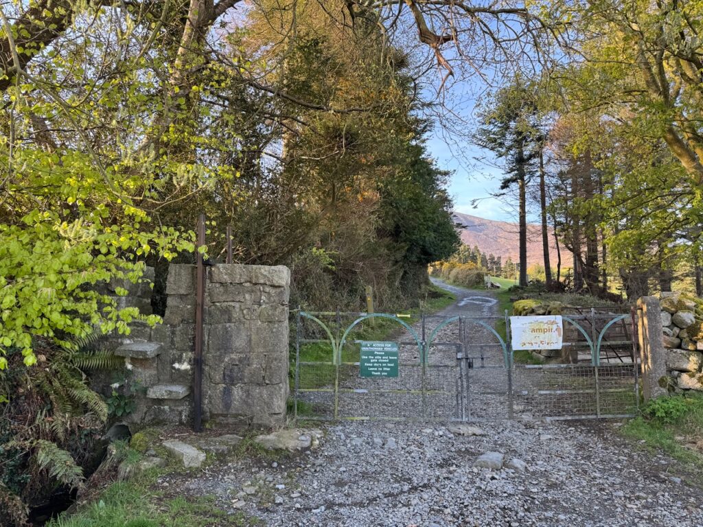 Entrance to the Slieve Bearnagh Hike on Trassey Track, with the stone stile beside the access gate.