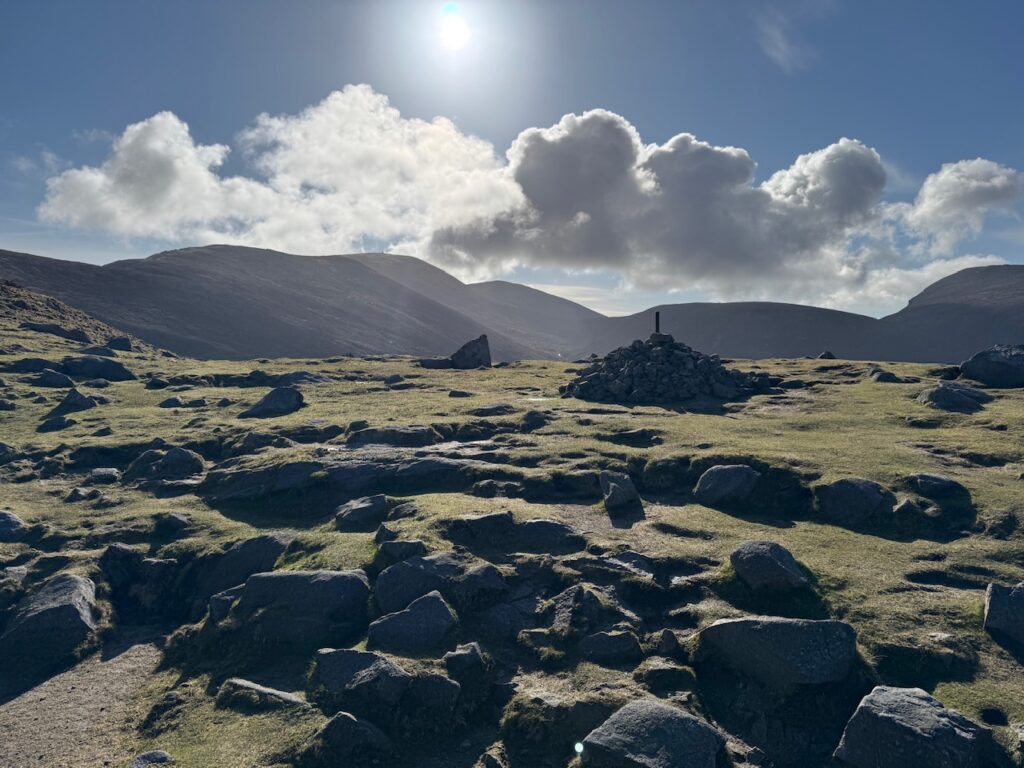 Cairn marking Hare’s Gap with panoramic views across the Mourne Mountains.