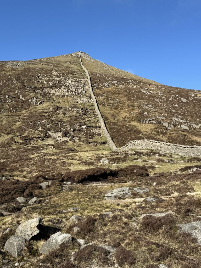 The Mourne Wall climbing towards Slieve Bearnagh North Tor on the Slieve Bearnagh Hike