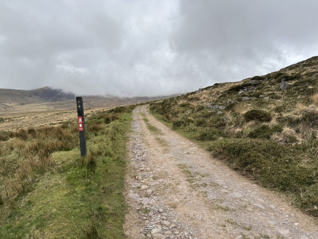 Gravel trail on the Masatiompan and Sauce Creek walk leading towards the cloud-covered slopes of Masatiompan.