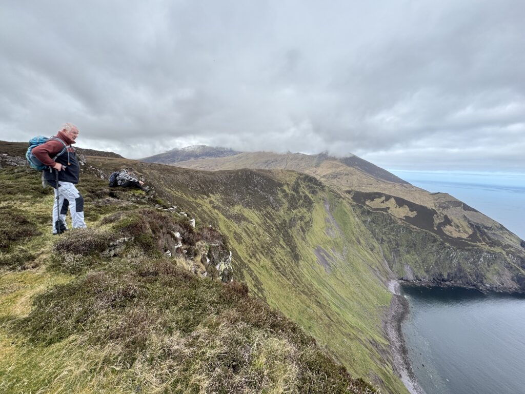 Hikers looking out over the dramatic cliffs of Sauce Creek during the Masatiompan and Sauce Creek walk on the Dingle Peninsula.