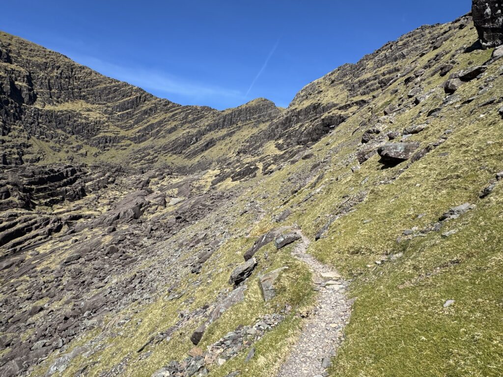 Rocky path through the dramatic Faha corrie, surrounded by the steep cliffs of the Brandon Mountains.