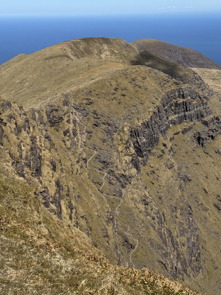 Zig-zag mountain path of the Éisc cutting across the steep rocky cliffs of the Brandon Mountains above the Atlantic.