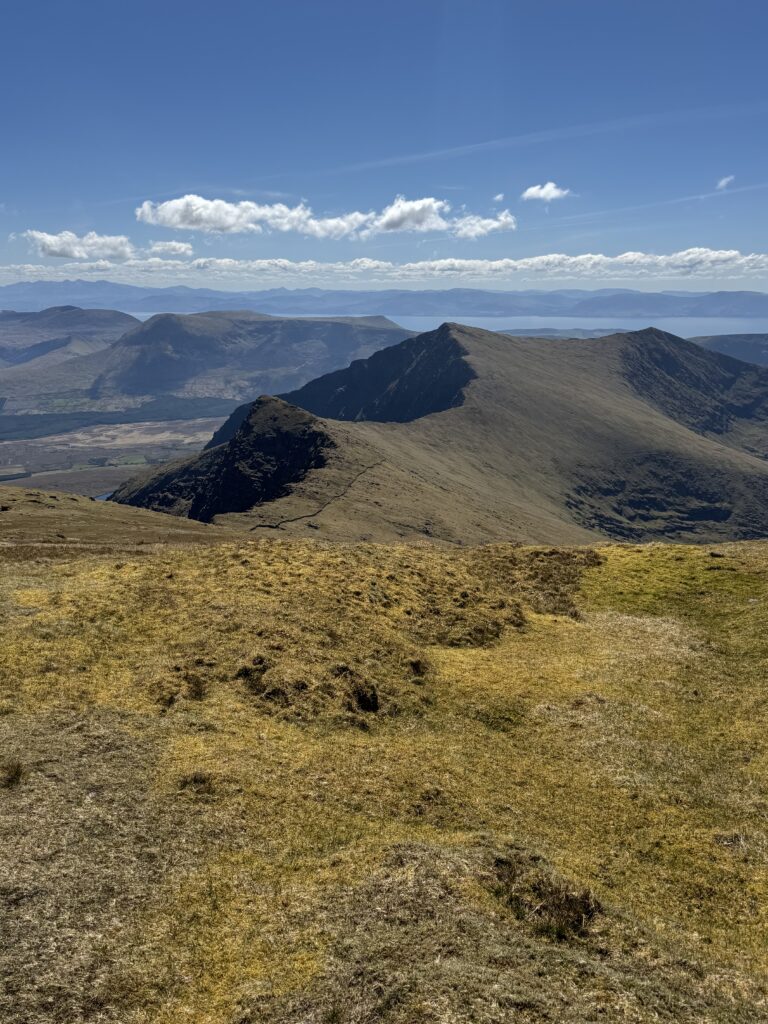Sweeping view across the rugged Brandon Mountains towards the distant mountains and coastline of County Kerry.