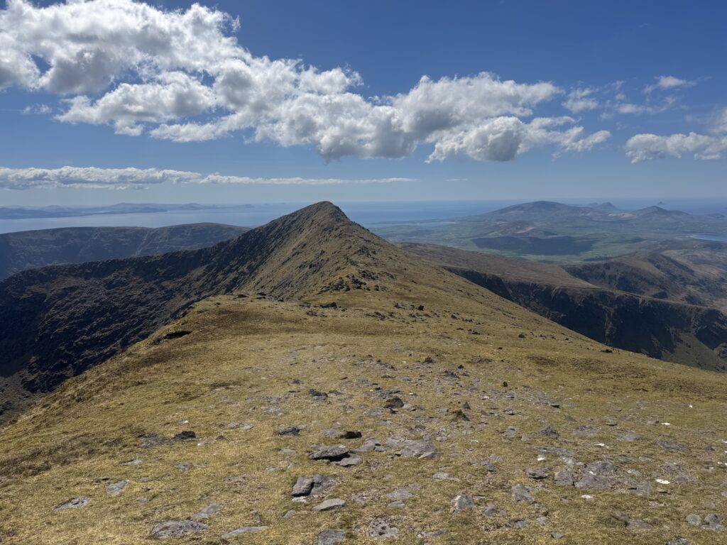 View along the mountain ridge towards Brandon Peak, with sweeping views across the Dingle Peninsula and Atlantic coast.