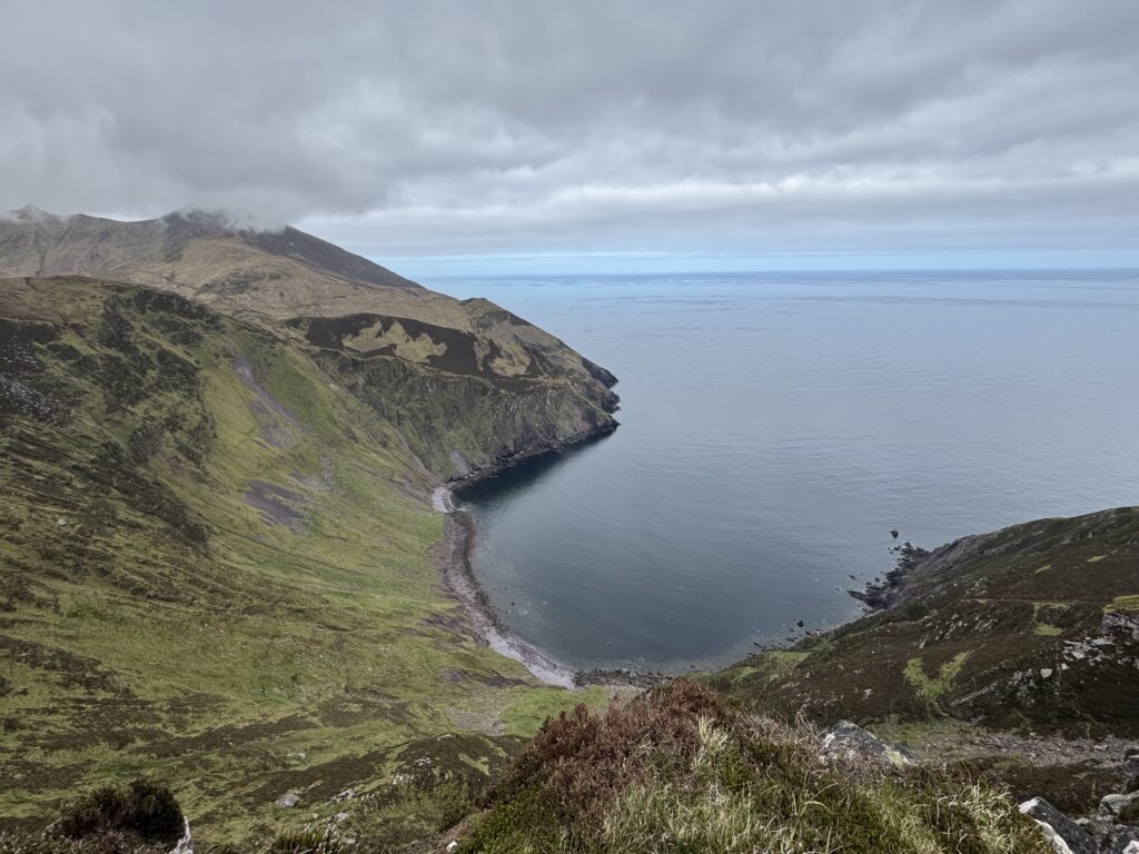 One of the best walks in Dingle, overlooking the dramatic cliffs and horseshoe-shaped cove of Sauce Creek, with rugged mountain slopes meeting the Atlantic Ocean.