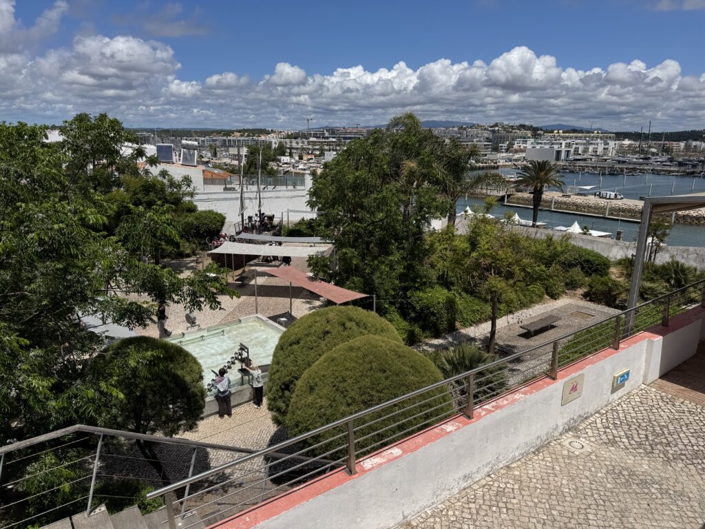 Elevated view of the outdoor gardens and interactive water feature at Lagos Science Museum, with the marina and town in the background, during our week in the Algarve with a 3 year old.